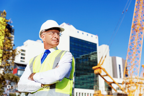 筑夢的剪影 建筑工地上穿安全背心的工程師與建設(shè)者